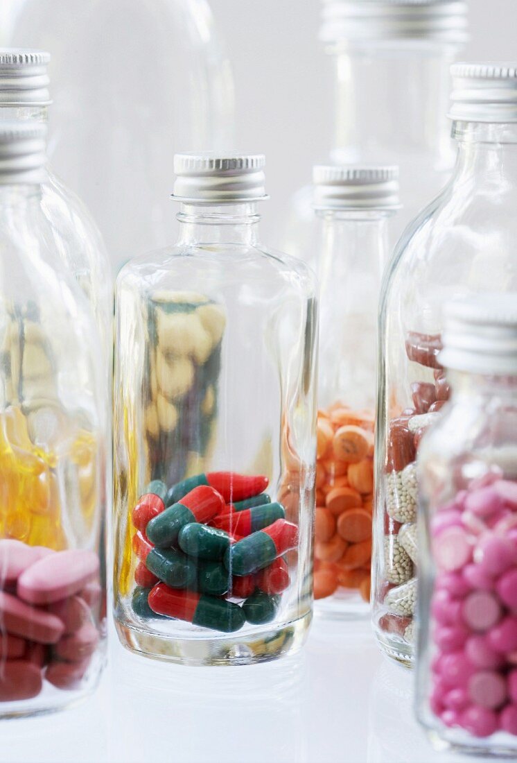 Assorted capsules and tablets in bottles