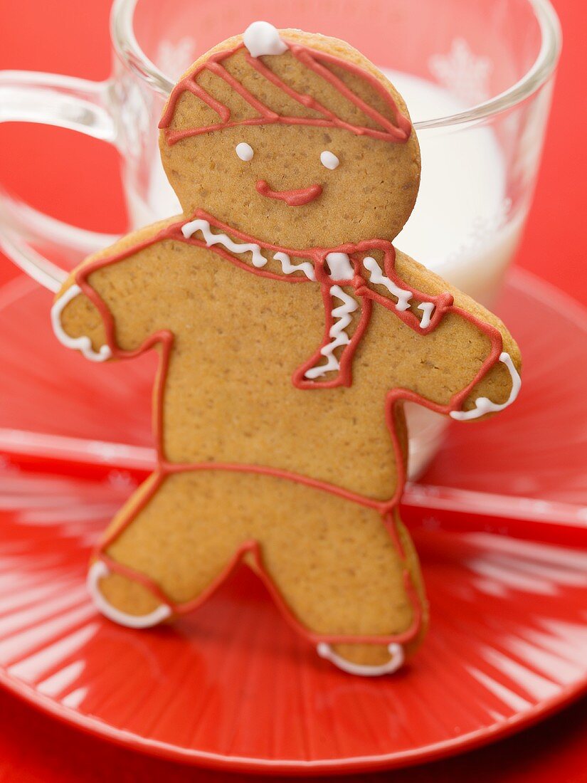 Gingerbread man in front of glass of milk