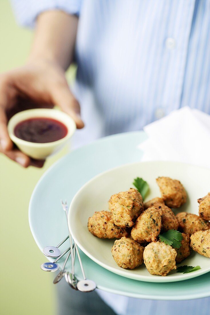 Person serving spicy fish balls