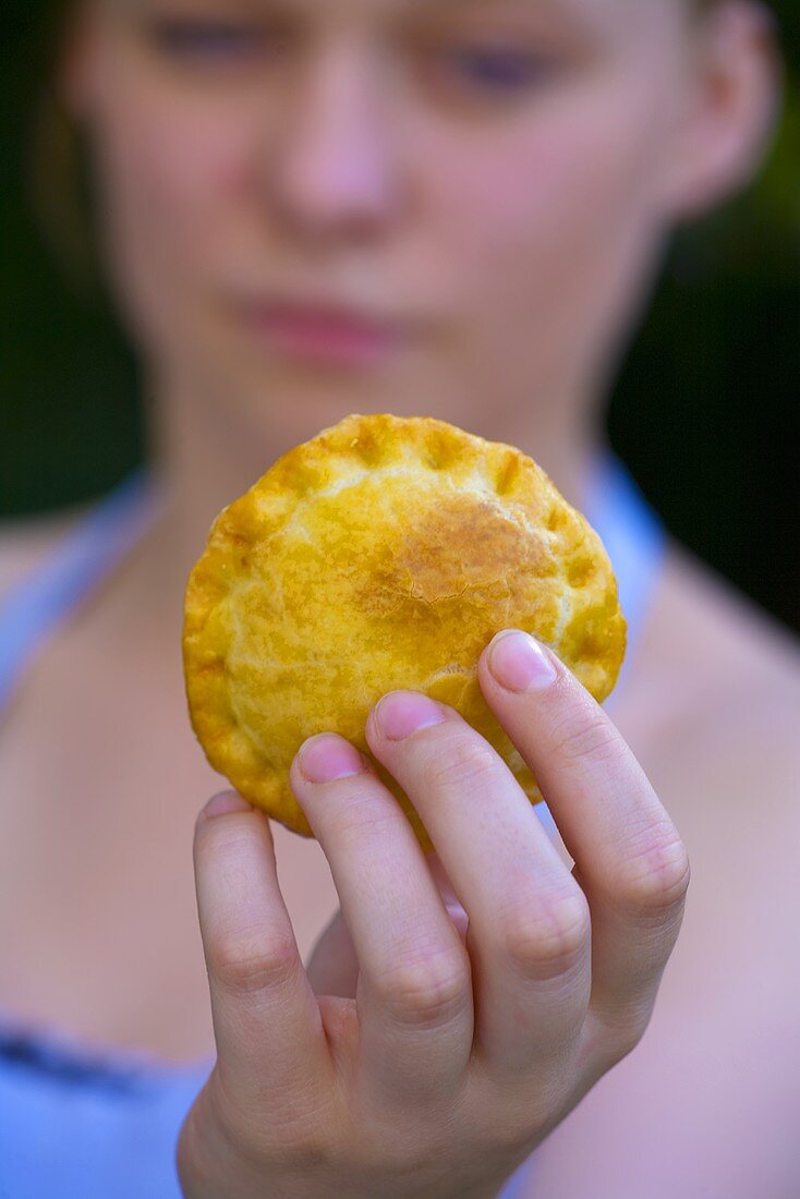 Woman holding meat pie