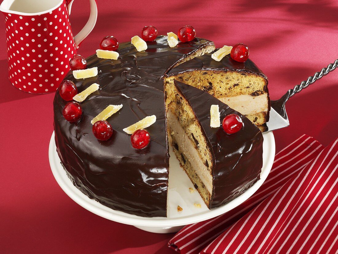 Banana cake with chocolate icing and cherries