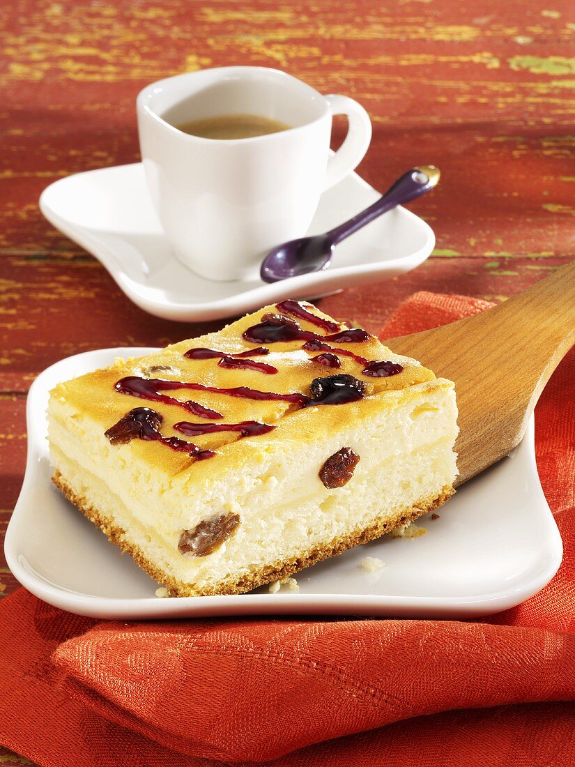 Piece of cheesecake with raisins, cup of coffee
