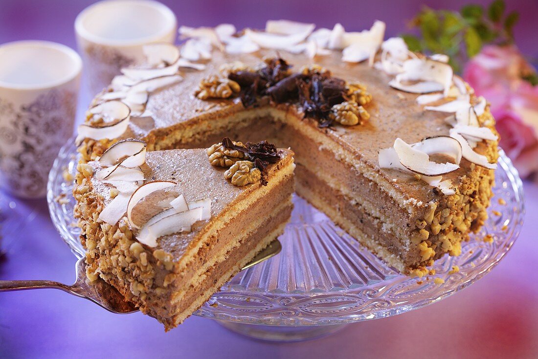 Nut cake with coconut shavings, a piece cut