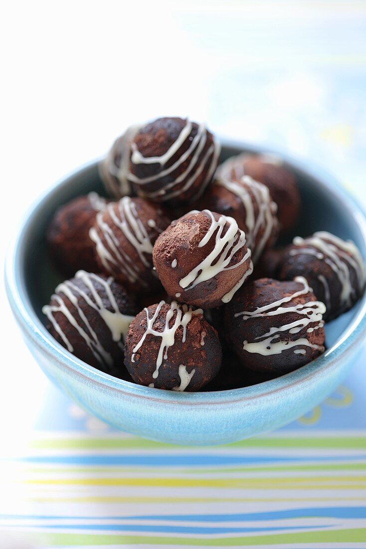 Chocolate truffles with drizzles of icing