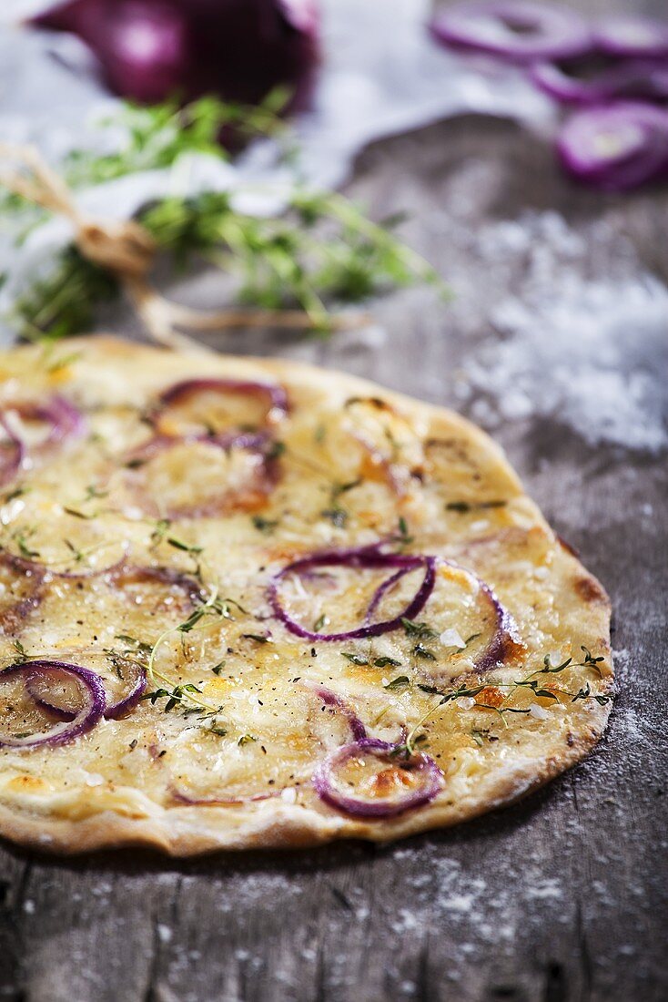Pizza topped with red onions