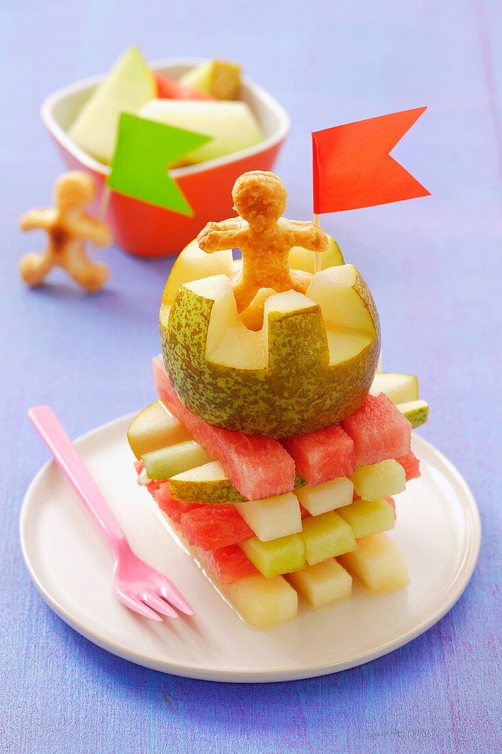 Tower of melon and pear with puff pastry men