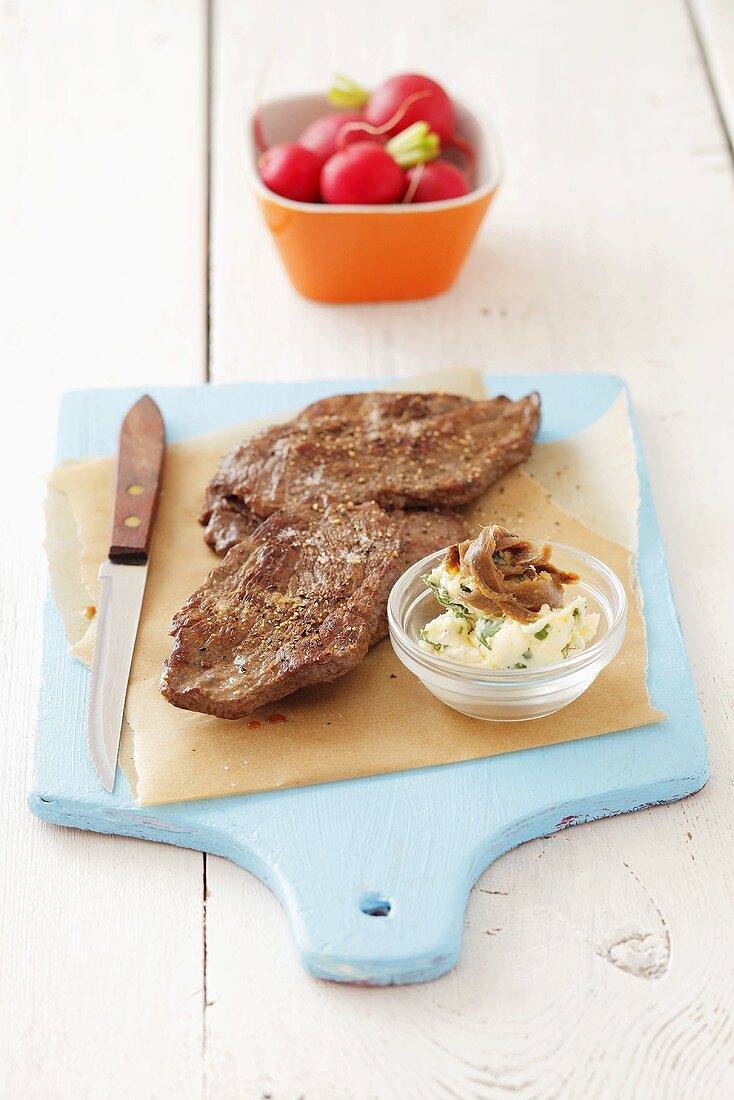 Fried rump steak and garlic butter with anchovies