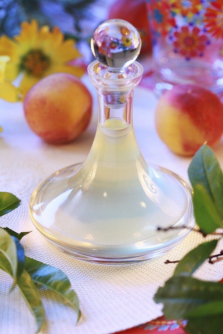 Home-made peach syrup in decanter