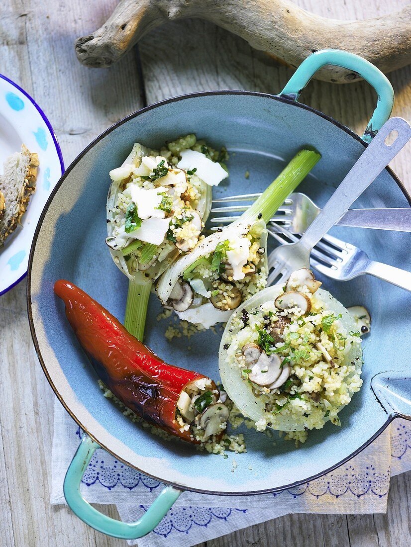 Fennel bulbs and red pepper stuffed with couscous and mushrooms