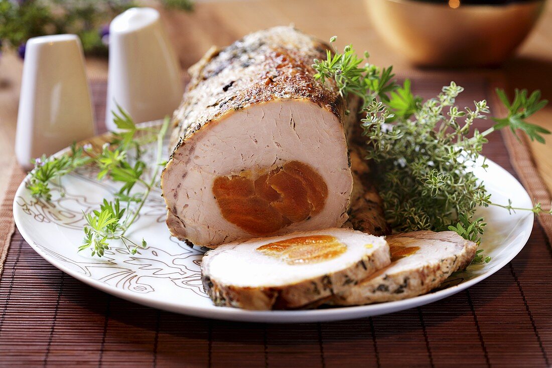 Roast pork with apricot stuffing, slices carved