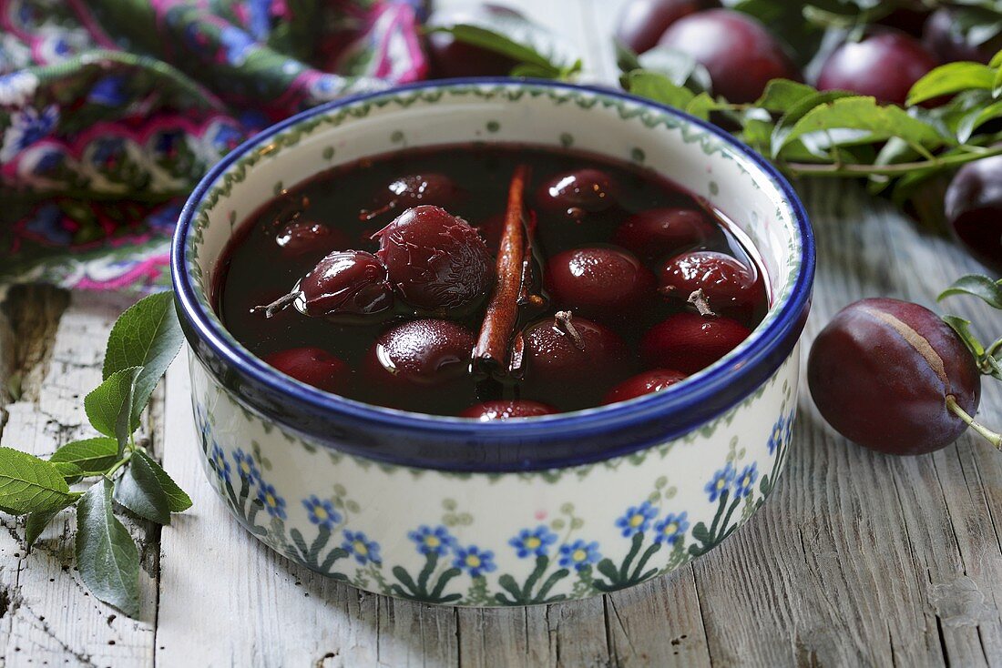 Plum compote with cinnamon stick