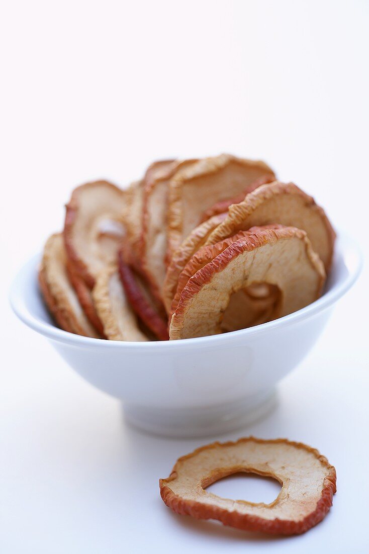 Dried unpeeled apple rings in a bowl