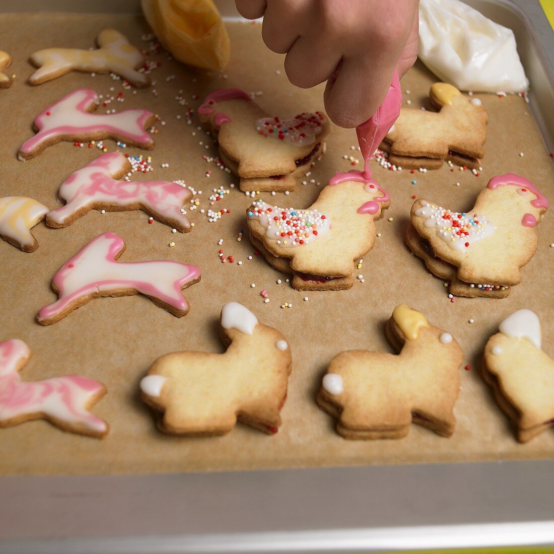 Icing animal-shaped Easter biscuits