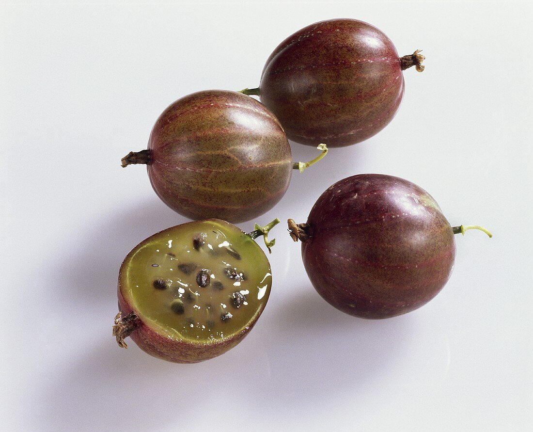 Red gooseberries, one halved