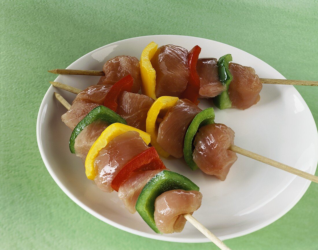 Three turkey kebabs with peppers