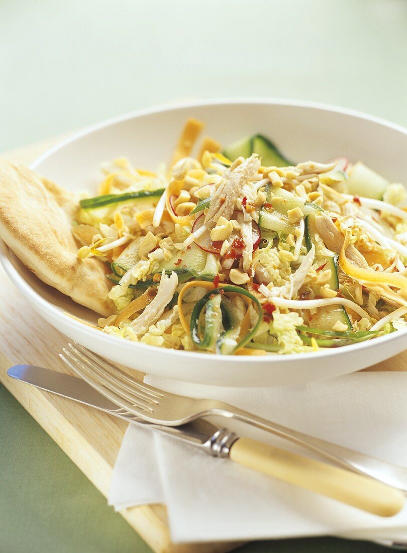 Asian salad with chicken pieces, peanuts and sprouts