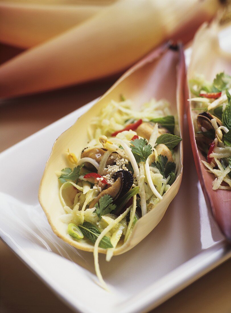 Vegetable salad with mussels in petal of a banana flower