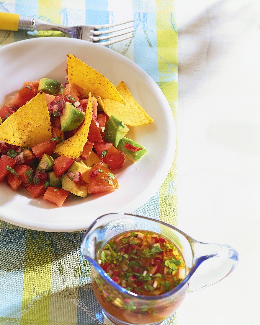 Tomato and avocado salad with corn chips