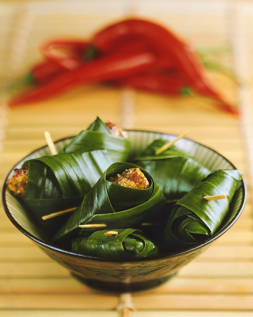 Marinated chicken pieces in banana leaves