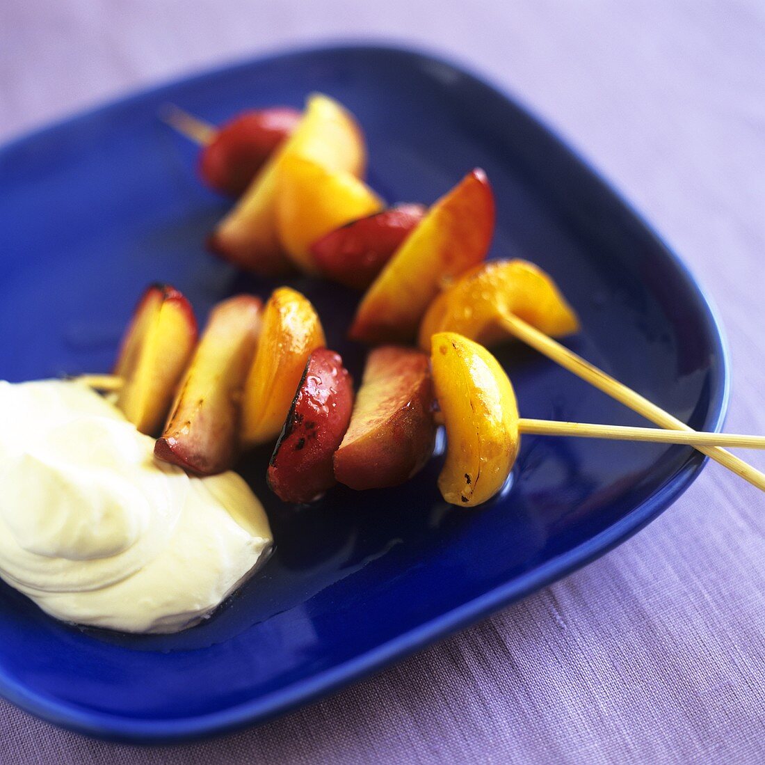 Grilled fruit kebabs with whipped cream