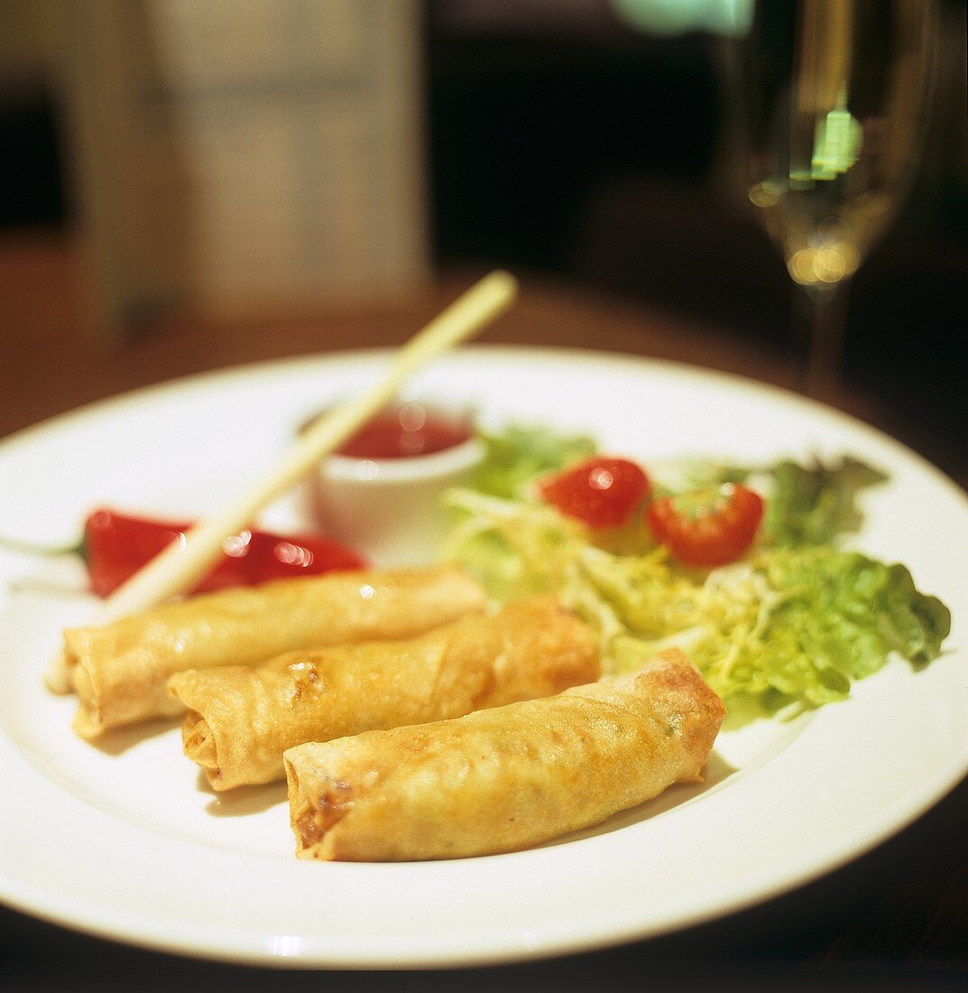 Three small spring rolls on a plate