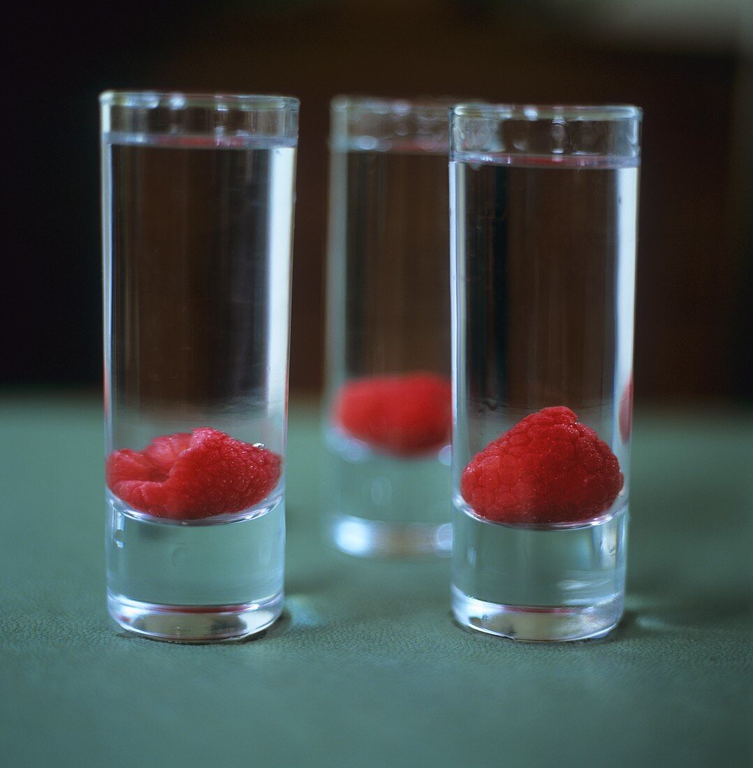 Vodka with raspberries in schnapps glasses