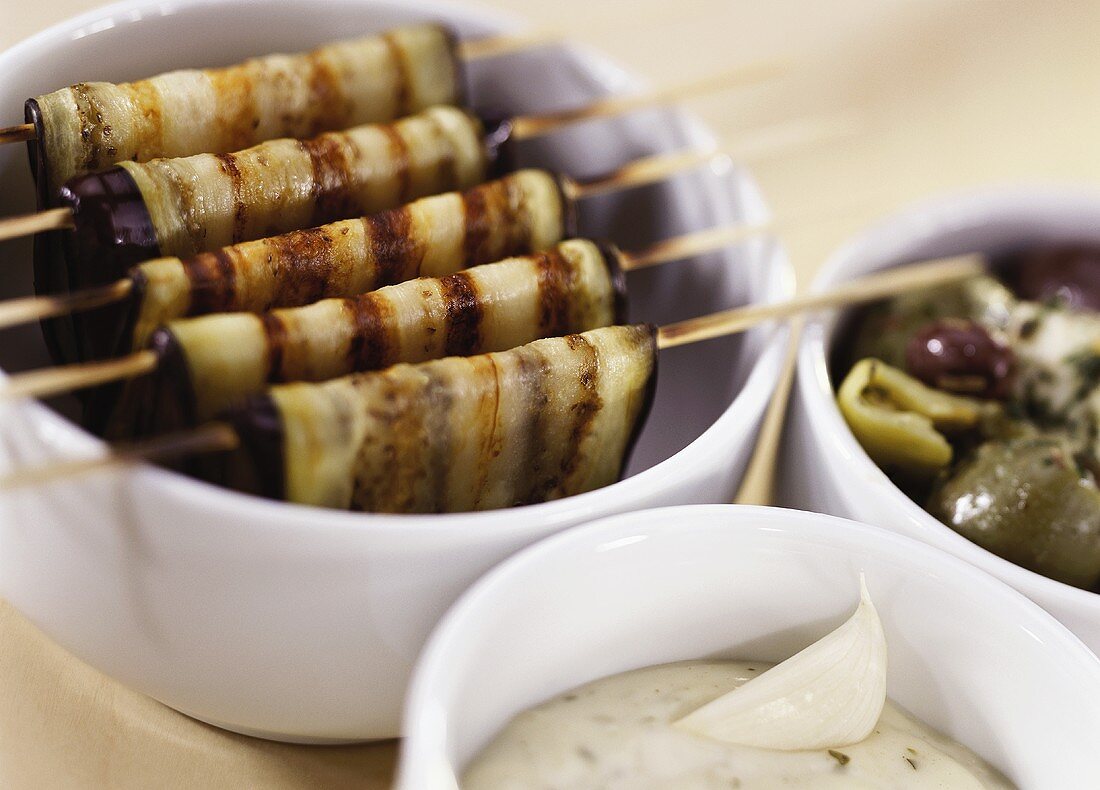 Barbecued aubergine slices, olives and garlic dip