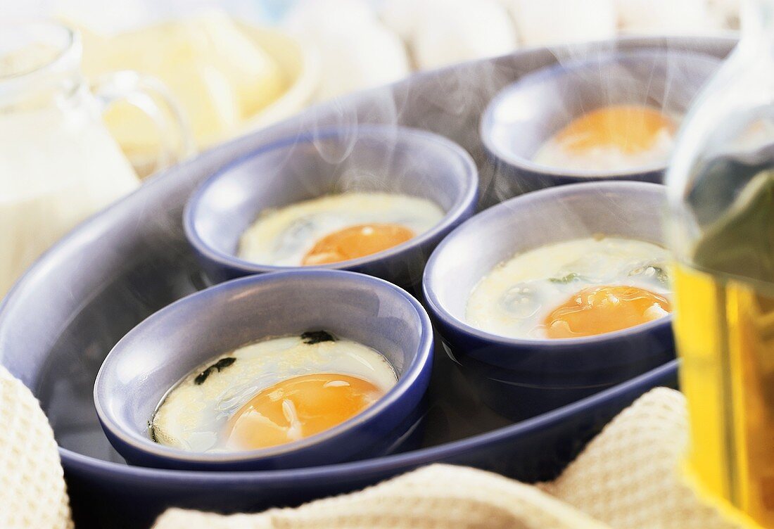 Eggs in moulds in bain-marie (making Eggs Florentine)