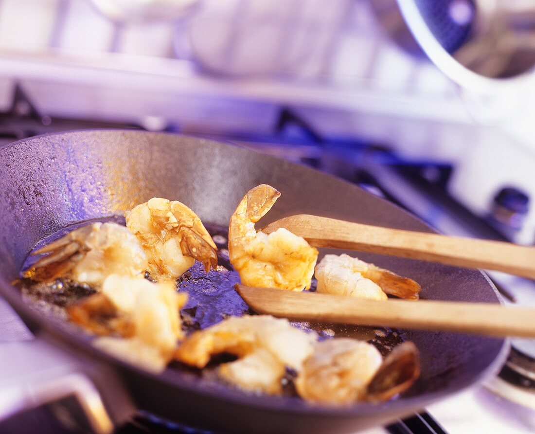 Frying shrimps in a frying pan