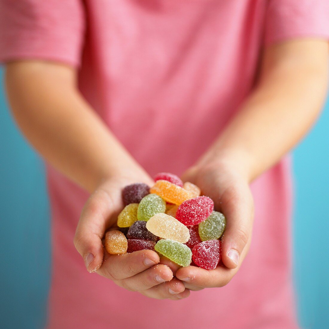 Assorted fruit jelly sweets, in someone's hands