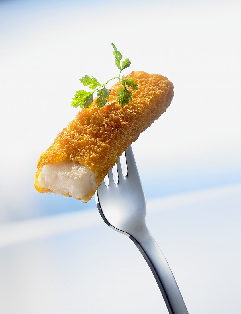 Fish finger, with a bite taken, speared on a fork