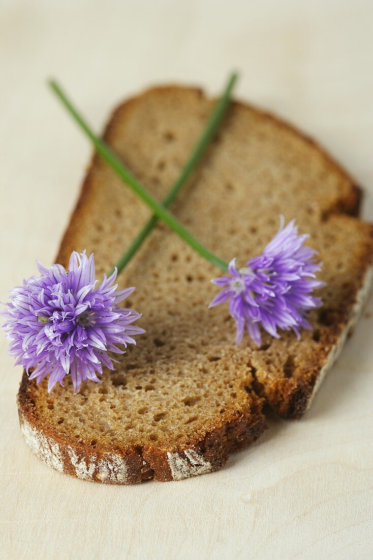 Flowering chives on slice of bread