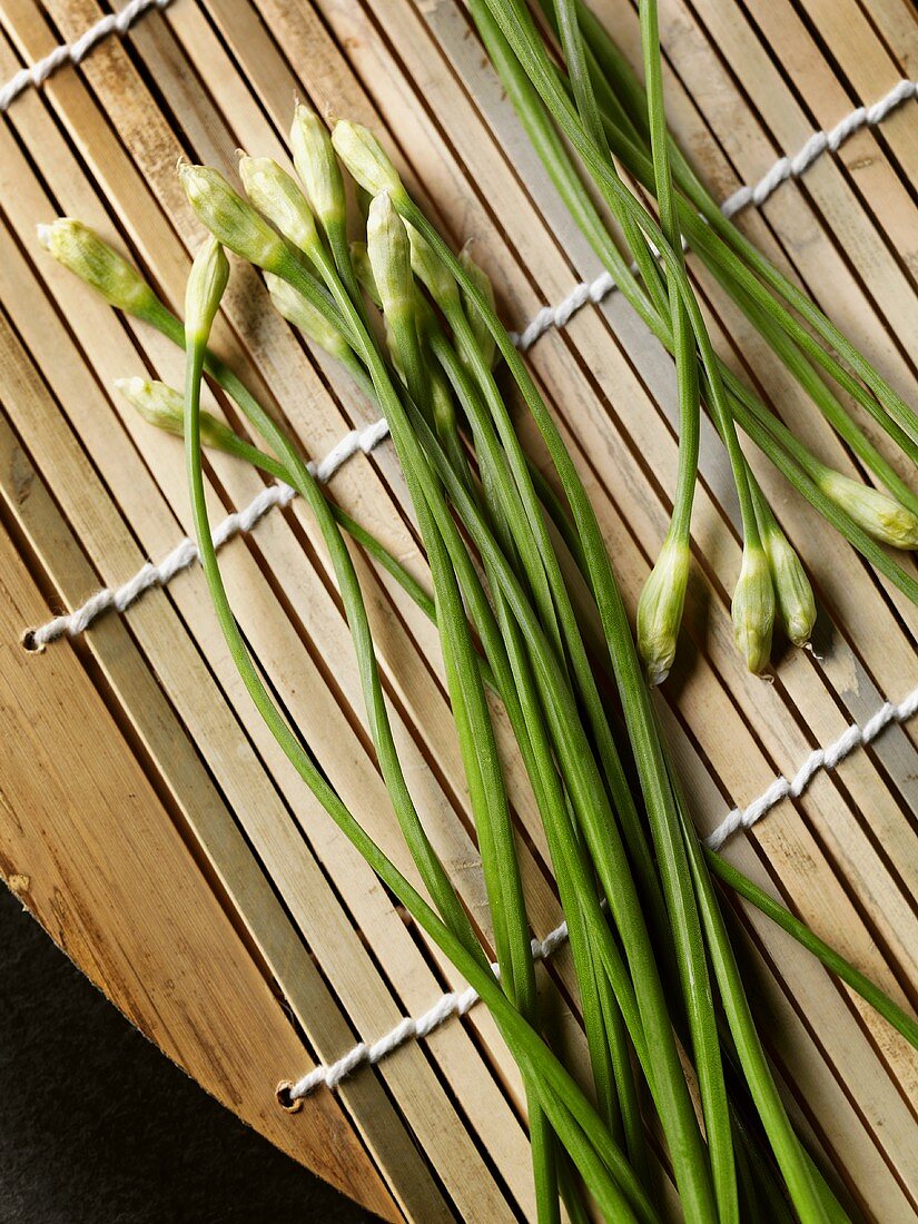 Chinese chives on bamboo background