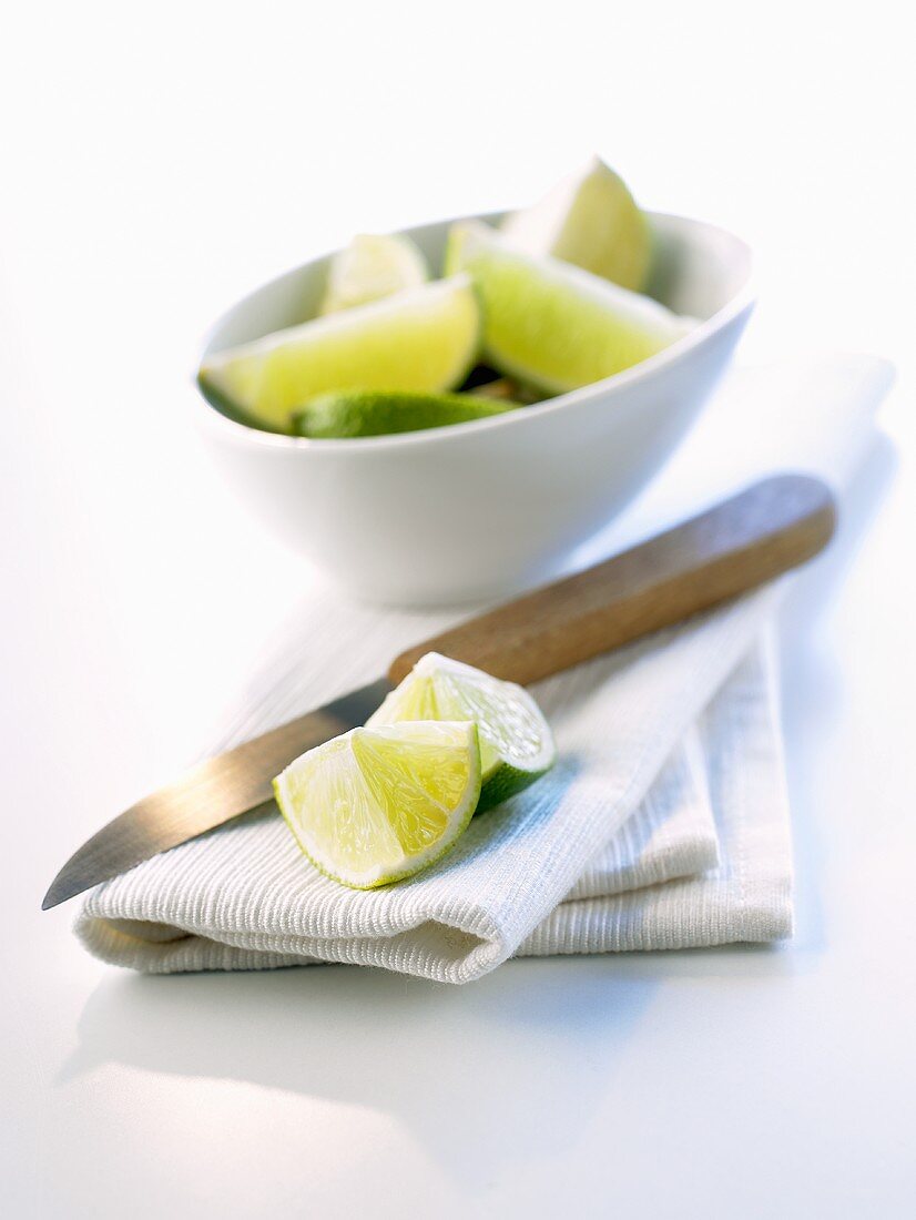 Kitchen cloth, kitchen knife and pieces of lime