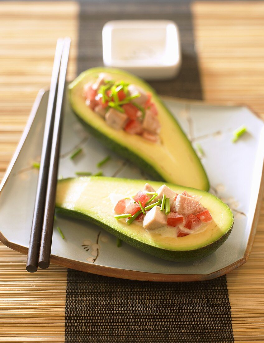 Avocado halves stuffed with pieces of tofu and tomato