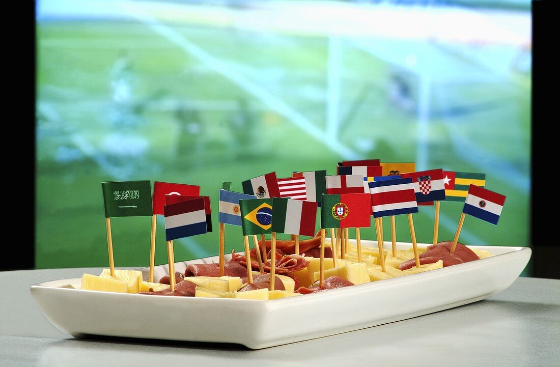 Ham and cheese on sticks with flags in front of television