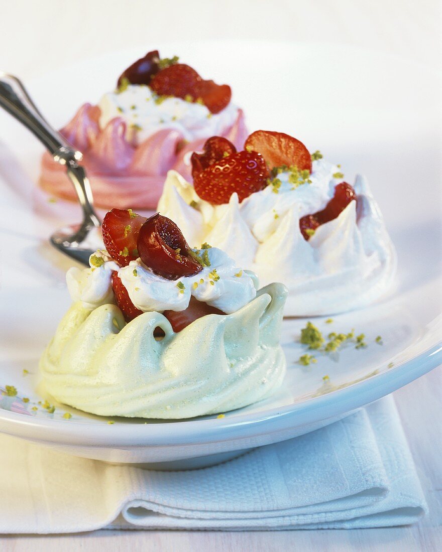 Three meringues with strawberries and whipped cream