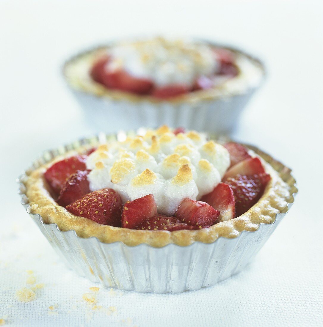 Two strawberry tarts with meringue topping