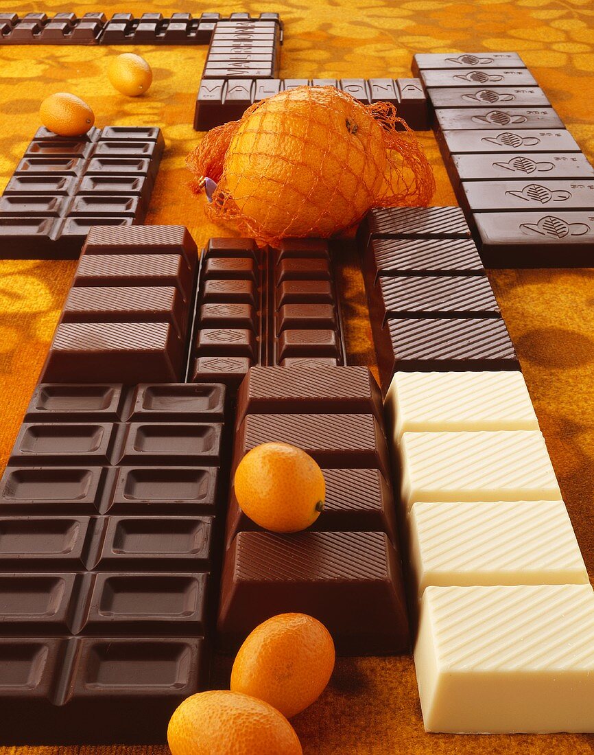 Still life of chocolate bars and citrus fruit