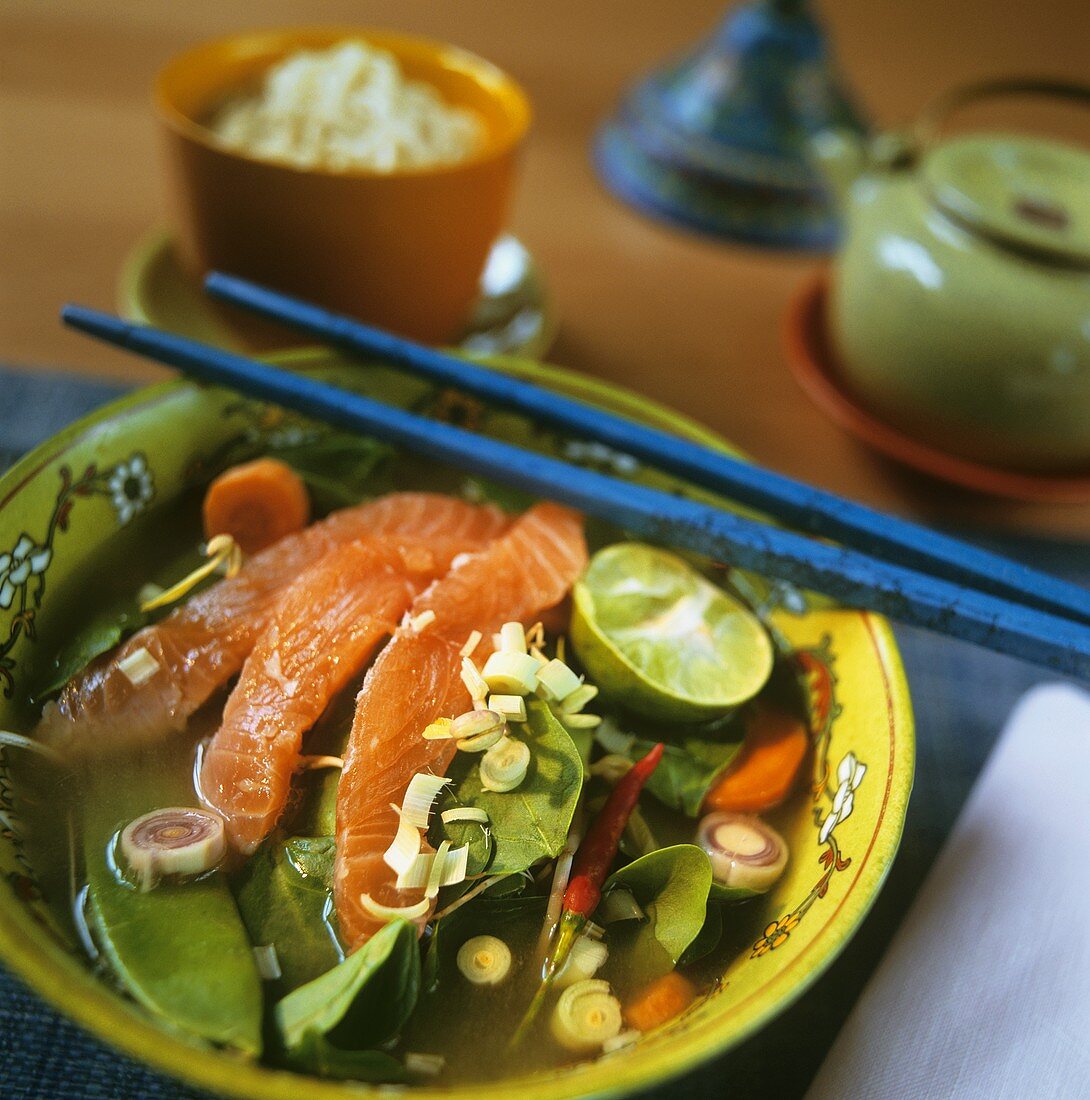 Raw salmon in marinade with vegetables