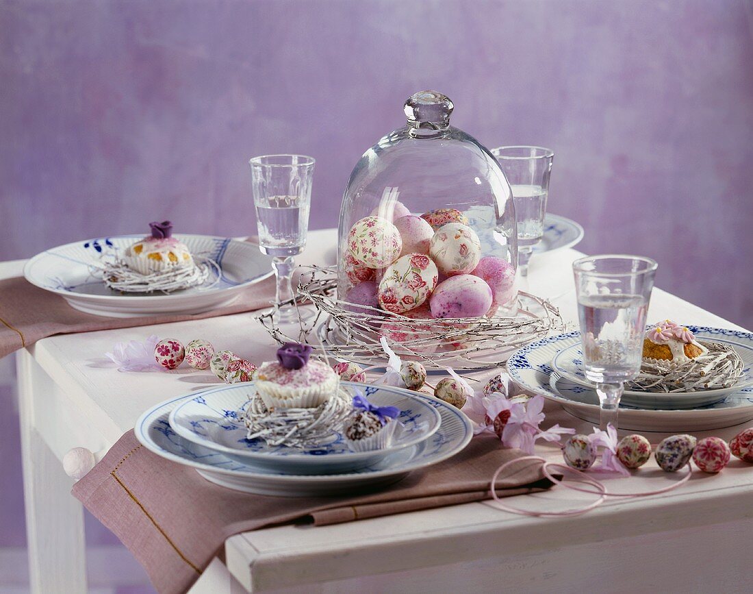 Laid Easter table with cakes and Easter eggs
