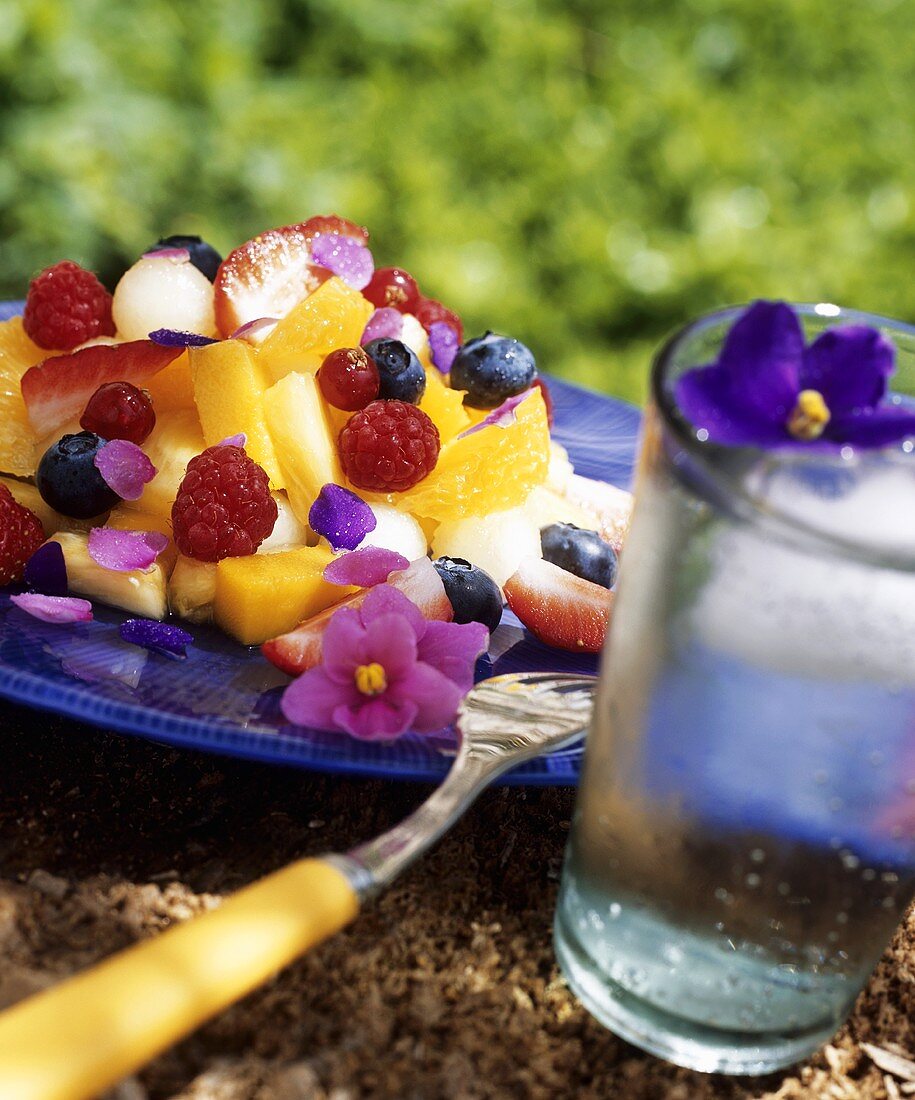 Fruit salad with berries and edible flowers