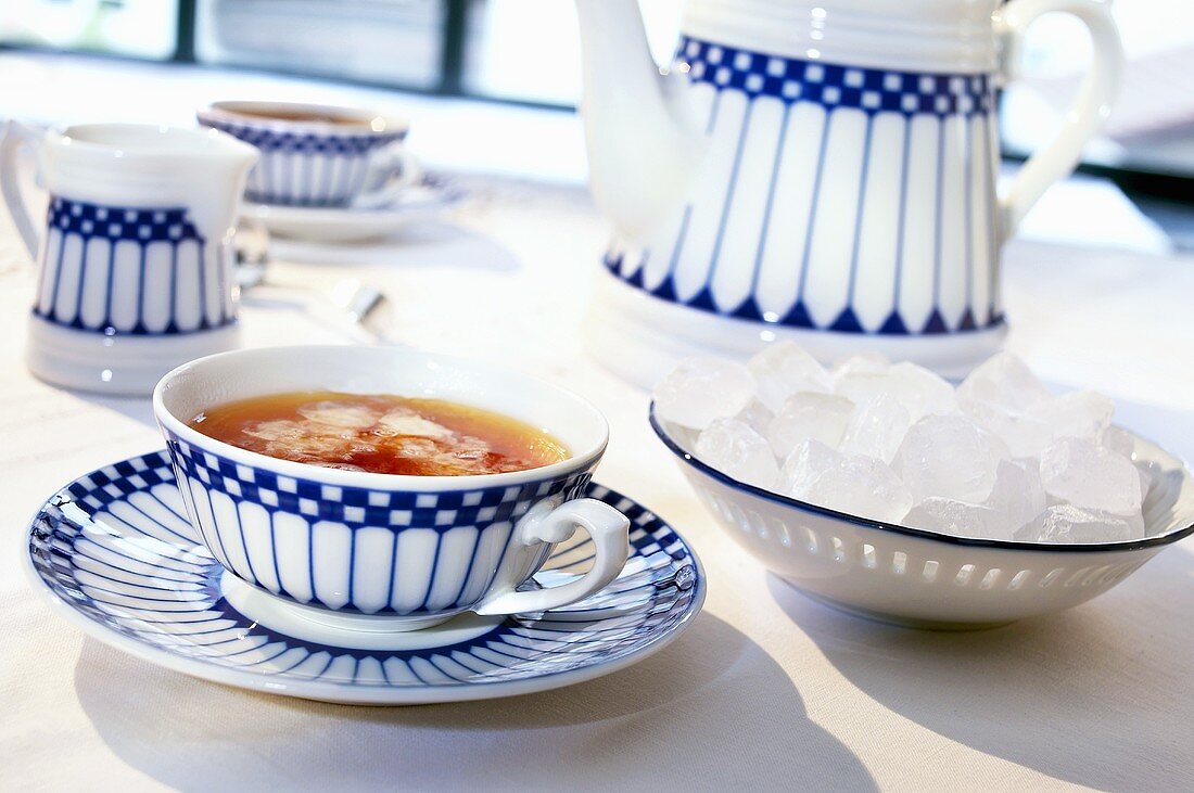 A cup of tea and sugar crystals