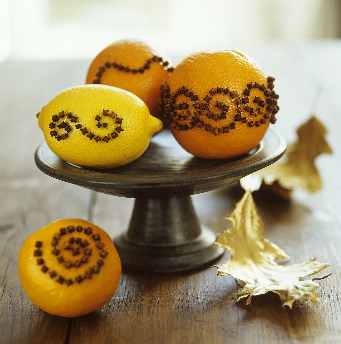 Oranges & lemon studded with cloves on a pedestal stand