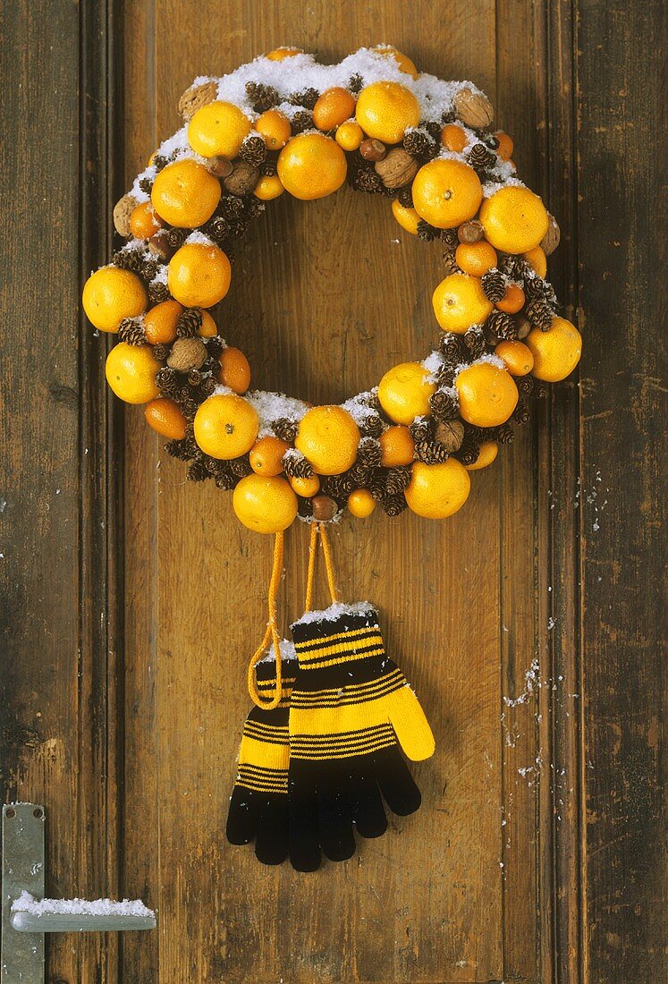 Door wreath of citrus fruit, nuts and fir cones