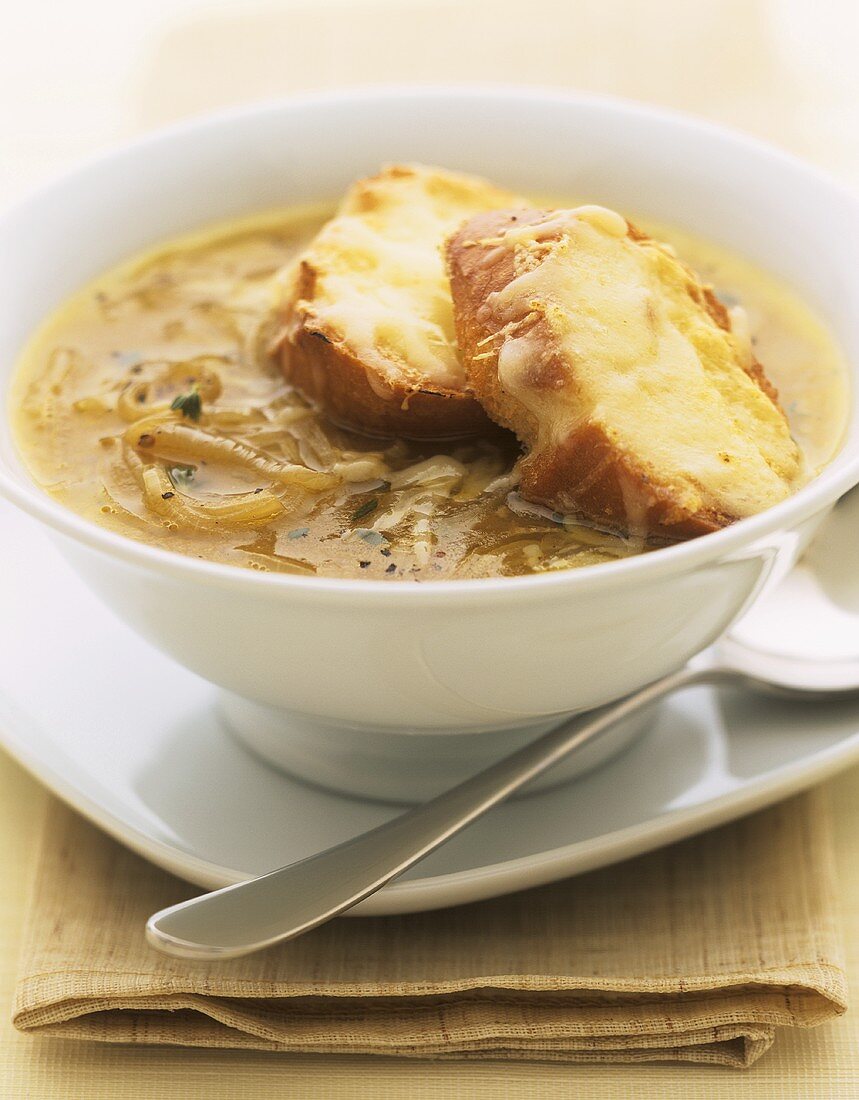 Onion soup with baguette slices topped with toasted cheese