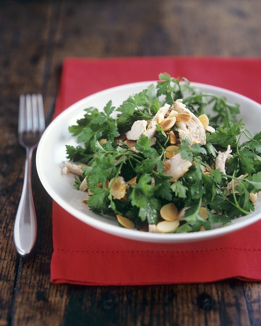 Parsley salad with chicken pieces and flaked almonds