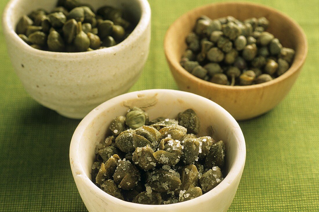 Capers in three small bowls