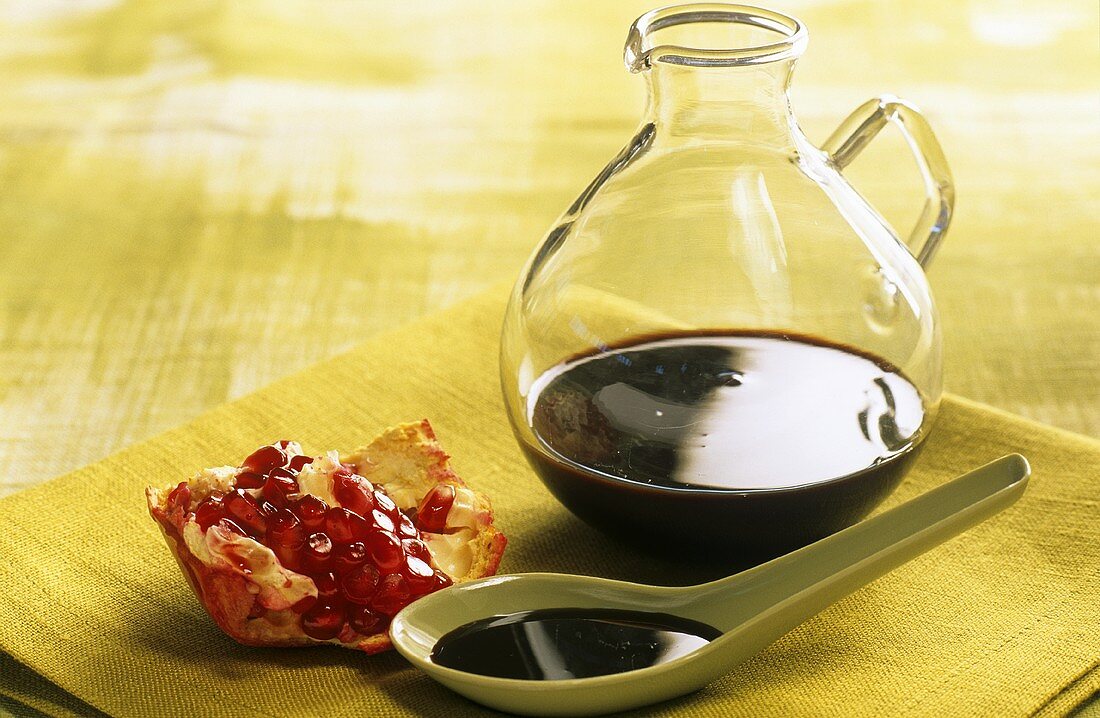Unsweetened pomegranate syrup in a carafe