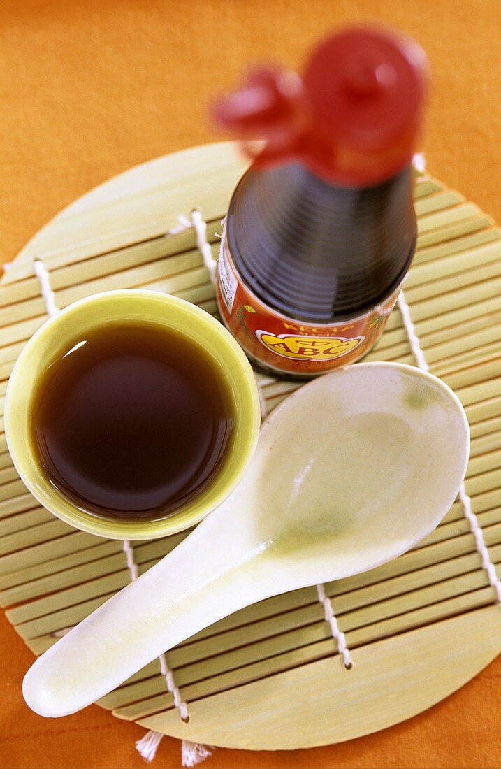 Soy sauce, in bottle and in small bowl